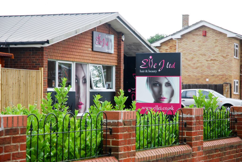 Hanging main sign, post sign, and one way vision digitally printed window graphic at Elle J - Gosport