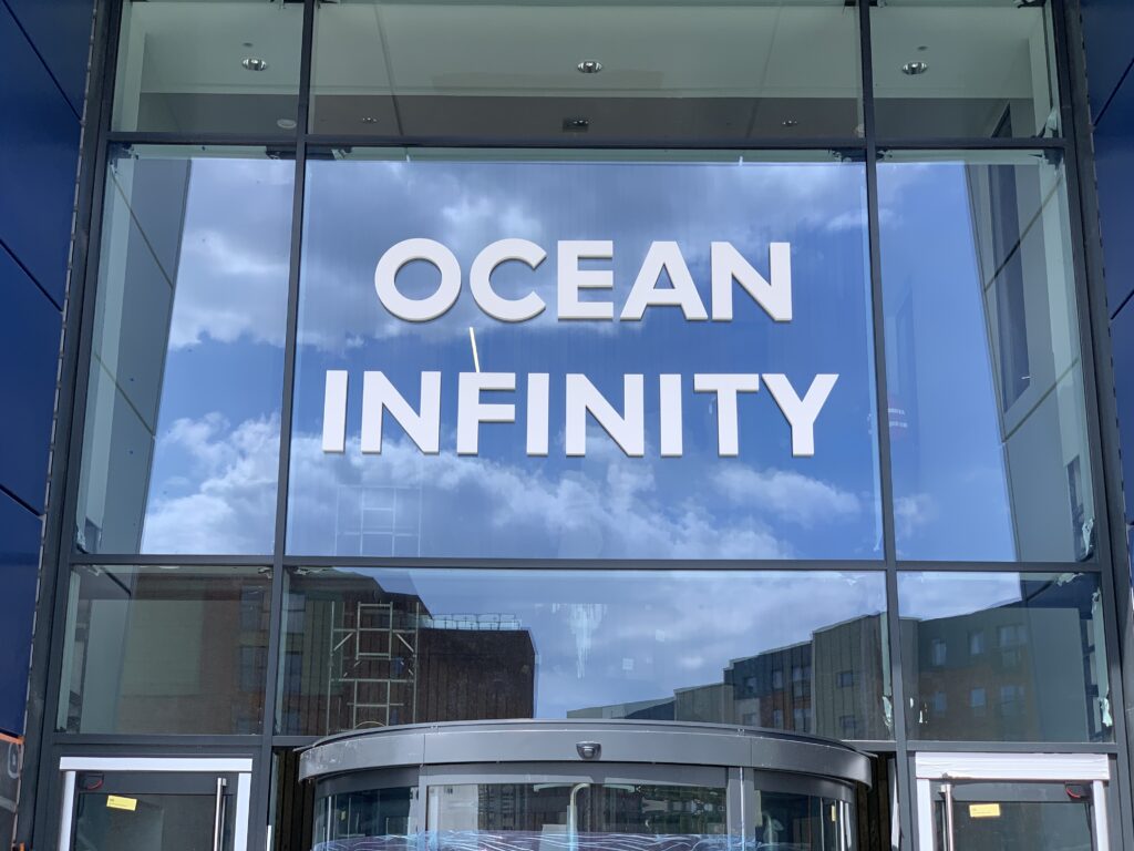 Ocean Infinity text, stuck directly to the glass front